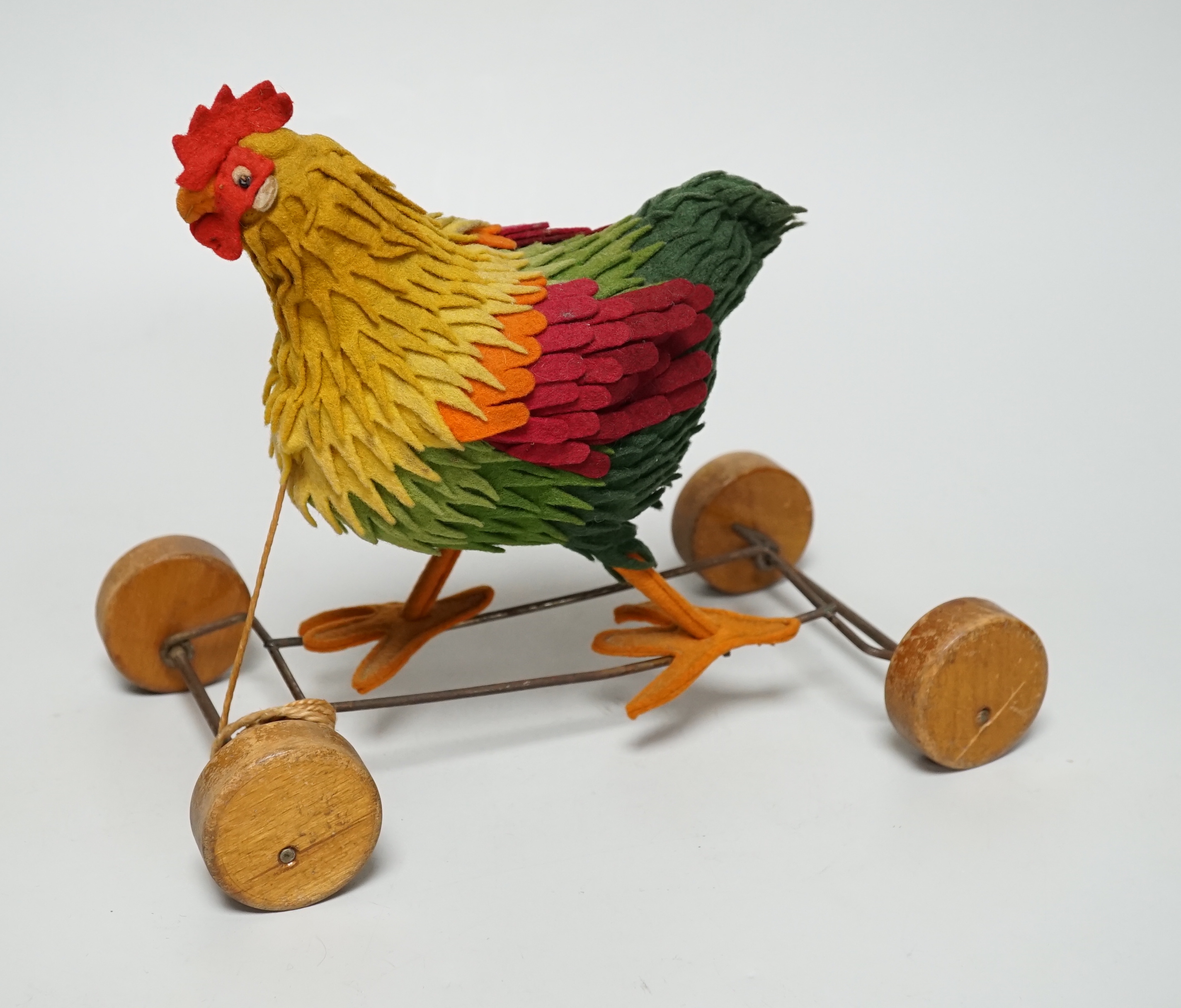 A Steiff cockerel on wooden wheel, c.1915, no button, good condition